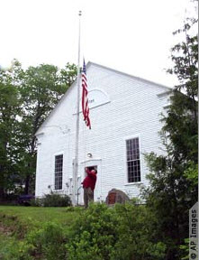 A selectman, an elected official, raises the American flag at the town hall in Sedgewick, Maine. The 1794 building is the Maine’s oldest town hall. (Photo: AP Image)