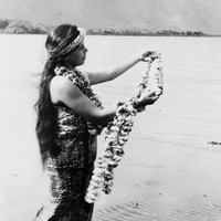 Photo of Hawaiian woman with lei on the beach
