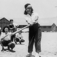 Photo of interned women playing softball, 1942