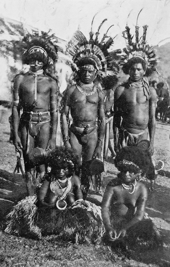 Black and white photo of men in traditional tribal dress