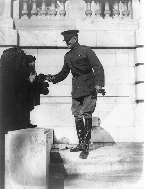 Pershing shaking hands with admirers