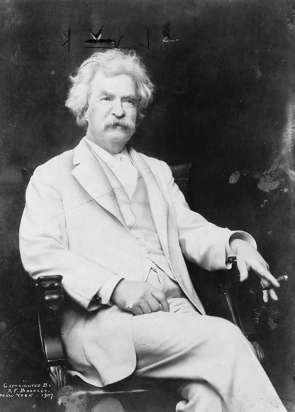 Portrait of Mark Twain, three-quarter length portrait, seated, facing slightly right, with cigar in hand.