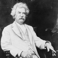 Portrait of Mark Twain, three-quarter length portrait, seated, facing slightly right, with cigar in hand.