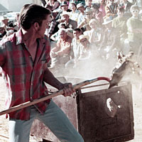 Photo of man participating in the Mucking Contest, n.d.