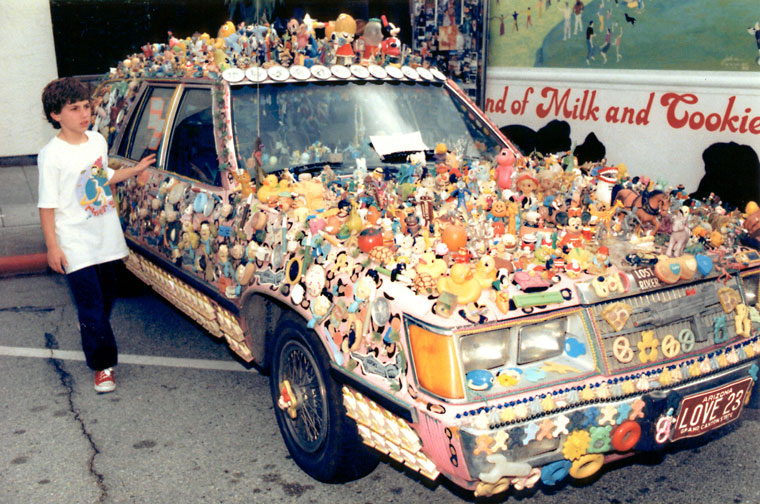 Photo of a pink car covered with small toys