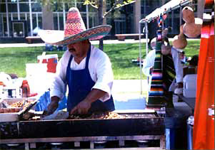 Photo of man wearing a sombrero at a grill