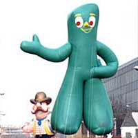 Photo of parade with giant Gumby balloon and marching band