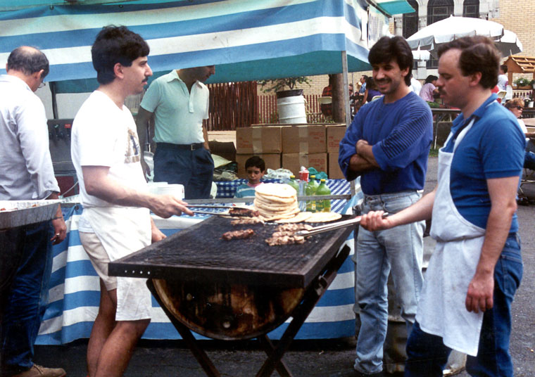 Photo of men at a food stand grill