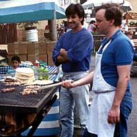 Photo of men at a food stand grill