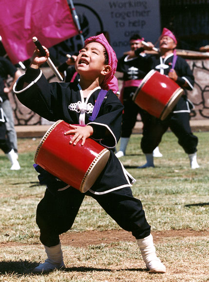 Photo of Young Taiko performer with other performers