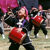 Photo of Young Taiko performer with other performers