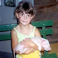 Photo of girl holding baby pig
