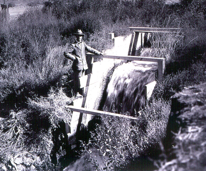 Photo of man at irrigation headgate