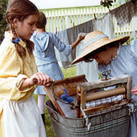 Photo of children at the museum washing clothes