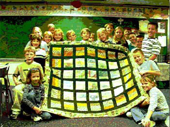 Photo of 3rd grade class at Brown Elementary School with quilt