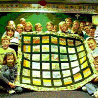 Photo of 3rd grade class at Brown Elementary School with quilt