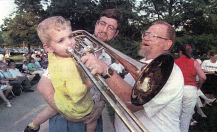 Photo of child trying out a trombone
