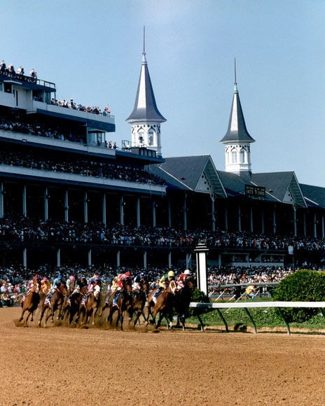 Photo of horses racing on the track at the Kentucky Derby