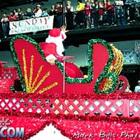 Photo of Santa waving to the crowd from a Christmas float