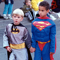 Photo of two children dressed as Batman and Superman