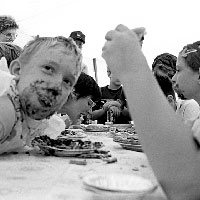 Photo of kids eating pie in a pie-eating contest