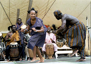 Photo of dancers in African dress with band playing behind