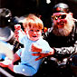 Photo of a biker holding up a young child