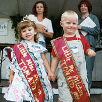 Photo of boy and a girl on stage wearing award sashes