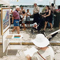 Photo of people walking around outdoor art booths