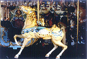 Photo of a gold and blue horse on a carousel