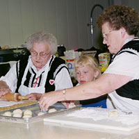Photo of two women and a girl making kolaches