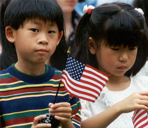 Photo of two children with small American flags