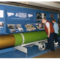 Photo of two visitors at exhibit on the Torpedo Factory's history