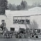 Photo of the front of school with students and teachers posed