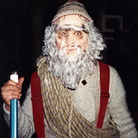 Photo of a person dressed up in a mask, hat, suspenders, and ropes