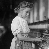 Portrait of a girl, standing, working at a machine in a textile plant, Cherryville, N.C.