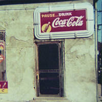 Natchez, Miss. Store or cafe with soft drink signs.