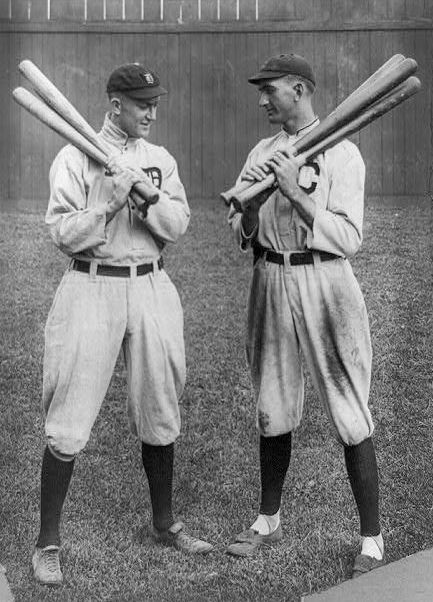 Ty Cobb and Joe Jackson, standing alongside each other, each holding bats.
