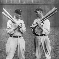 Ty Cobb and Joe Jackson, standing alongside each other, each holding bats.