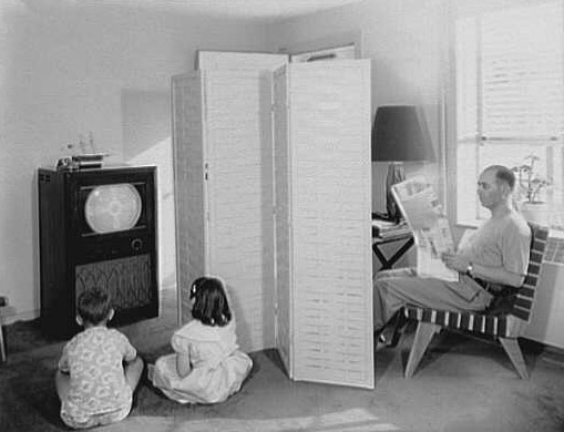 Father Reading Newspaper, Children Viewing Television