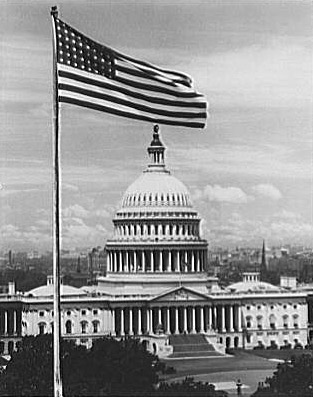 U.S. Capitol exteriors. Flag and east front of U.S. Capitol.