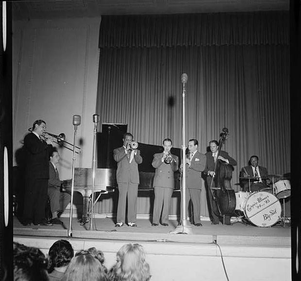 Portrait of Jack Teagarden, Dick Carey, Louis Armstrong, Bobby Hackett, Peanuts Hucko, Bob Haggart, and Sid Catlett, Town Hall, New York, 1947.