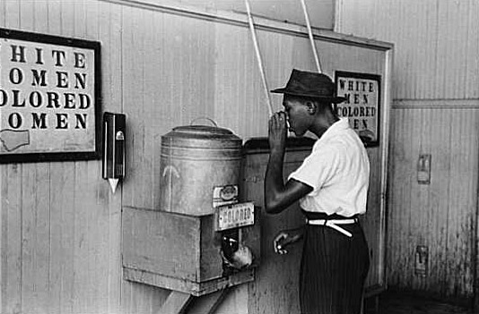 'Negro Drinking at 'Colored' Water Cooler in Streetcar Terminal, Oklahoma City, Oklahoma,' 1939.