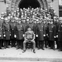 Group of New York City(?) policemen posed in front of police station