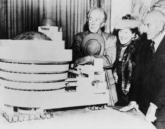 Frank Lloyd Wright, Baroness Hilla Rebay, and Solomon R. Guggenheim standing beside a model of the Solomon R. Guggenheim Museum, 1947