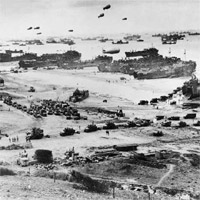 Bird's-eye view of landing craft, barrage balloons, and allied troops landing in Normandy, France on D-Day