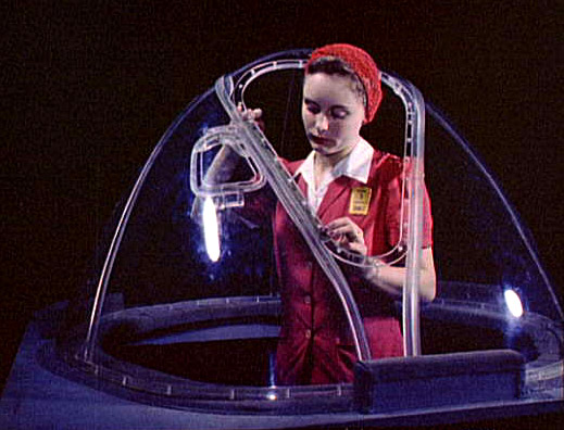 Girl putting finishing touches on the bombardier nose section of a B-17F navy bomber