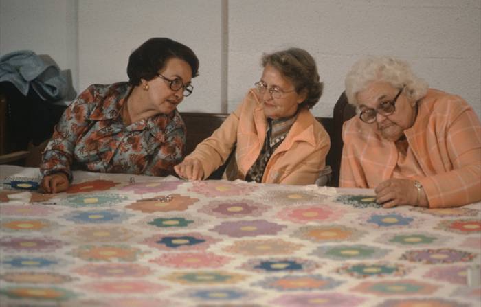 Ilene Flint, Vera Stanley, Ruth Spangler on side of quilt frame, 1978.
