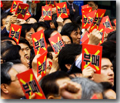 Citizens show anti-corruption cards in
Seoul, Korea on May 3, 2002 to protest government corruption scandals