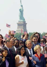 President George W. Bush stands with 29 newly naturalized U.S. citizens